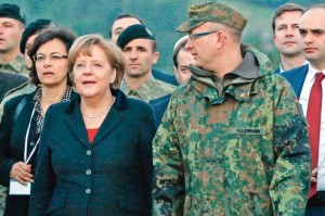 Germany's Chancellor Merkel is escorted by commander of German troops in Turkey Colonel Ellermann as she arrives at Turkish military base in Kahramanmaras