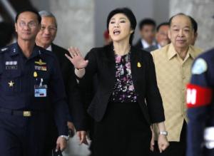 Thailand's Prime Minister Yingluck Shinawatra gestures as she leaves after a cabinet meeting in Bangkok