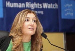 HRW Middle East director Whitson talks during a news conference in Doha