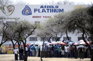Striking mine workers gather outside the Anglo American Mine on October 5, 2012 in Rustenburg. South African police on October 5 recovered the body of a miner killed in clashes with striking workers at the platinum mine, as President Jacob Zuma appealed for an end to months of often violent industrial disputes. Miners said the man was killed late on October 4 when police used tear gas and rubber bullets to disperse a group of illegal strikers from the mine. Some 28,000 workers have been on a strike at Anglo American Platinum (Amplats), the world's top platinum producer, since September 12, demanding higher wages. AFP PHOTO / STEPHANE DE SAKUTIN (Photo credit should read STEPHANE DE SAKUTIN/AFP/GettyImages)