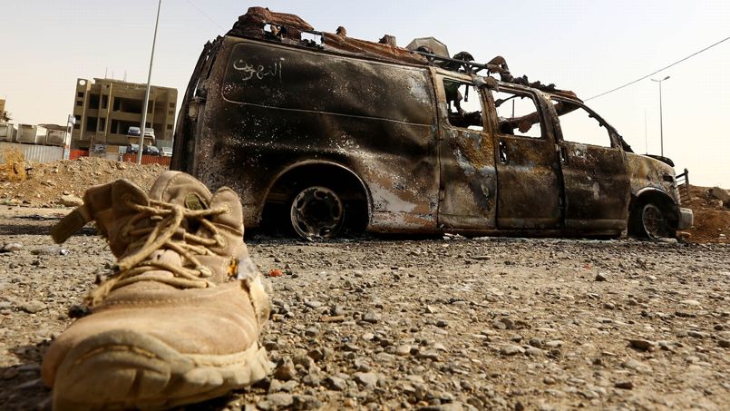A burnt vehicle belonging to Iraqi security forces is pictured at a checkpoint in east Mosul, one day after radical Sunni Muslim insurgents seized control of the city
