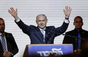 Israeli Prime Minister Benjamin Netanyahu waves to supporters at the party headquarters in Tel Aviv